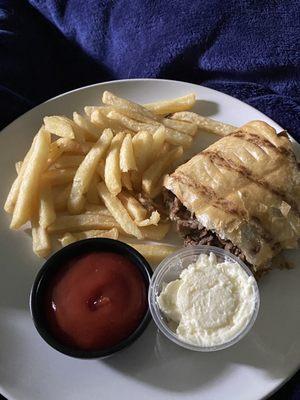 Crispy Roasted Garlic Cheese Steak Wrap with a side of Fries with mayo and ketchup