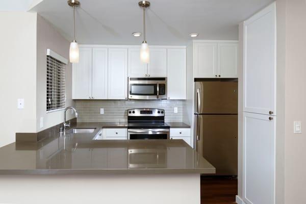 Kitchens with Quartz Countertops, Tile Backsplash, and Stainless Steel Appliances