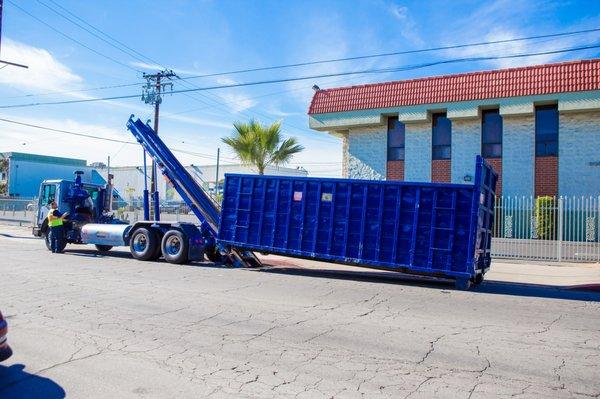 Truck dropping off rolloff