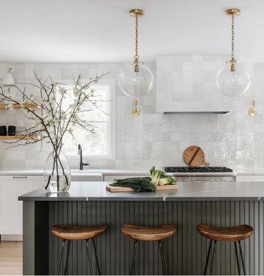 Chic black kitchen counter with stools exudes modern elegance, merging style and functionality for a sophisticated culinary space.