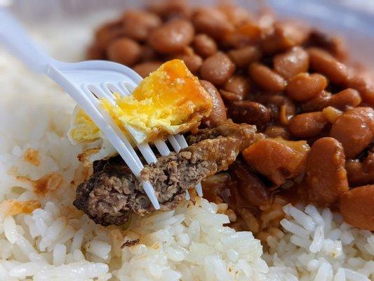 A bite of Bistec al Caballo with rice and beans. $12.95. Includes salad too.