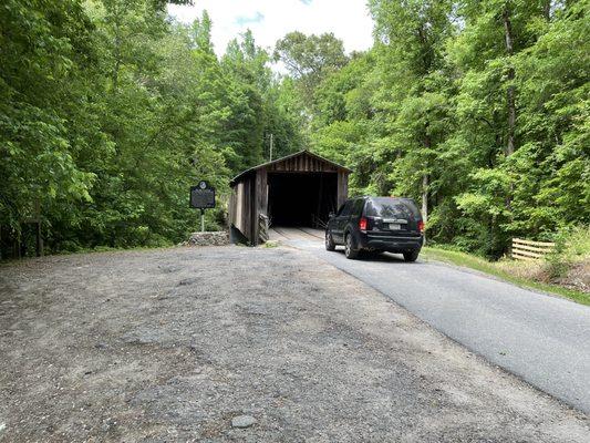 A vehicle approaches the bridge to drive through it.