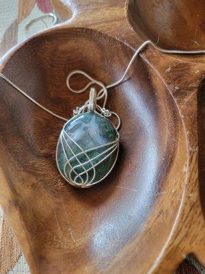 Intricate wire-wrapped mossy agate pendant