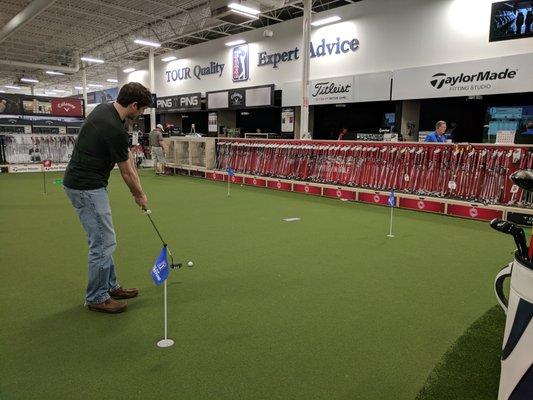 Putting green. They have many putters you can try for free.