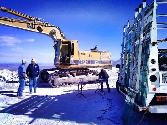 Installing glass in heavy equipment