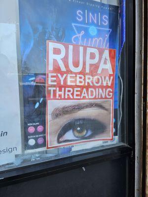 Signage advertising the eyebrow threading