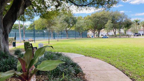 Grassy Area with Picnic Benches, shade, and Doggie Bags