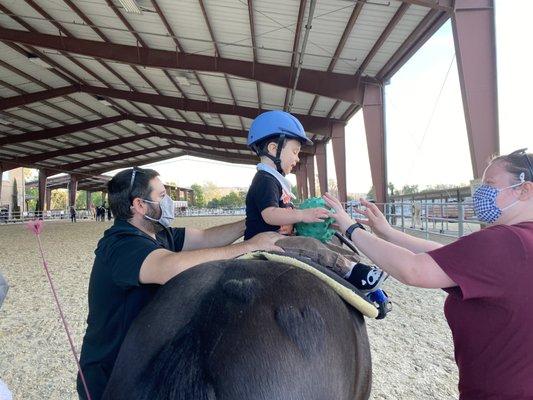 Father and mother particpating in Hippotherapy