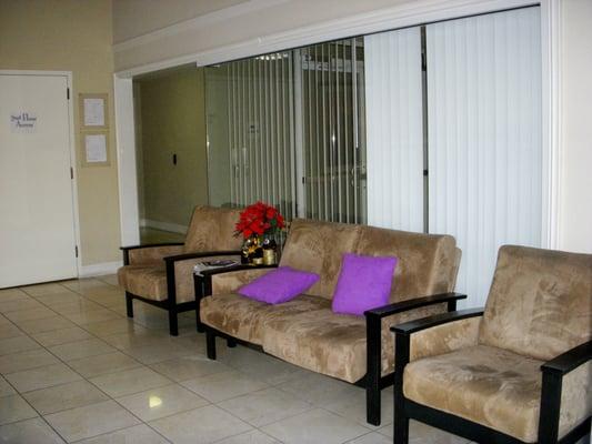 Waiting area with conference room behind the chairs.