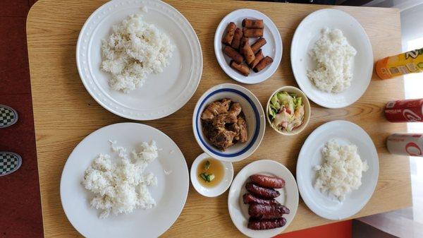 Longanisa, chicken adobo, chop suey with shrimp, lumpiang shanghai, and rice. Drinks on the side with condiments