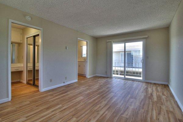 bright living room with hardwood floors at Ranchero Plaza Apartments