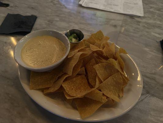 Chips and queso.  Glad to see the jalapeños on the side are fresh.