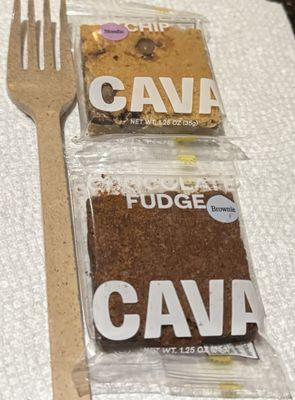 Two Cava Brownies next to a disposable fork. Tiny brownies.