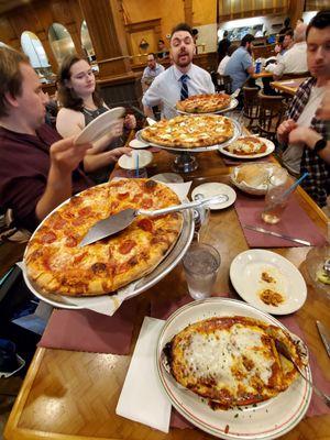 Various small size pizzas and an order of eggplant parmesan along with Red Rose House Salad