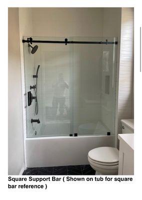 New Acrylic Tub & shower combo with 12"x24" porcelain tile, Frameless euroglide glass enclosure.  Single shampoo niche.