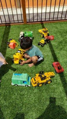 Playing with construction and garbage trucks