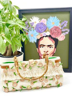 The Frida handbag bring together textile, leather, bamboo, and skilled embroidery to create a unique piece of wearable art.