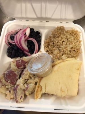 Rice, black beans, potato salad, pita bread, hummus & onions on top