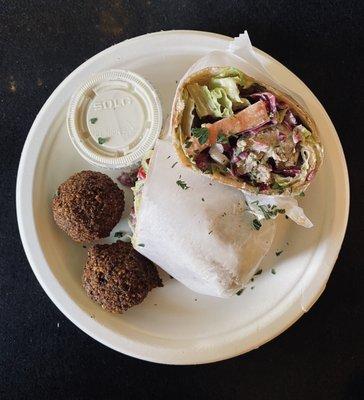 Lamb Kabab wrap with two pieces of Falafel and tahini sauce.