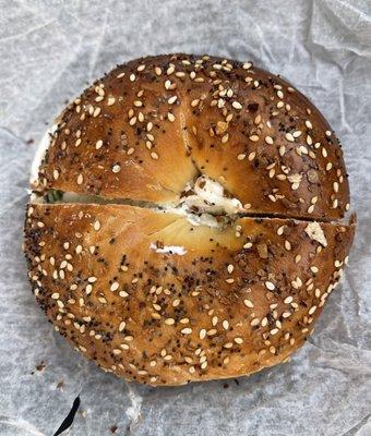 Scallion cream cheese on an everything bagel