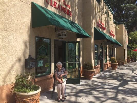 Sitting in front of Russell Heath Cleaners is the original owner and operator Winifred Heath (Russell Heath's widow)