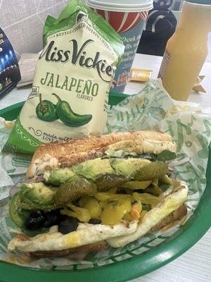 Breakfast sandwich toasted with pepper cheese and veggies with jalapeños  And Jalapeño chips   (Yeeez)