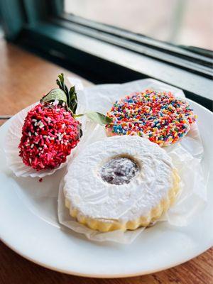 Linzer, Chocolate covered strawberry, shortbread cookie with sprinkles.