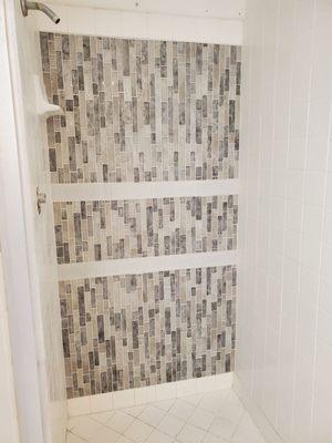 We had repaired a damaged shower wall and were not able to get replacement tiles, so we chose to use a mosaic to add a feature wall.