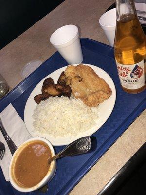 White rice, sweet plantains, fried fish and a cup of red beans. To drink, meregue flavored country club soda.