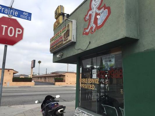 Outside the Key & Locksmith shop. It's on the corner and green (hard to miss)