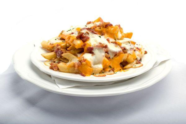 Plate of Cheecho Fries: Crispy golden french fries covered in melted cheese and crispy bacon bits from Genova's To Go.