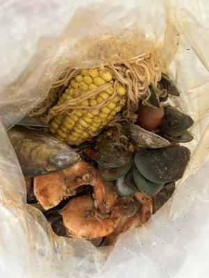 Combo #1 with shrimp, mussels, clams, sausage, corn, potatoes, instant noodles, mild spicy with Atomic sauce.