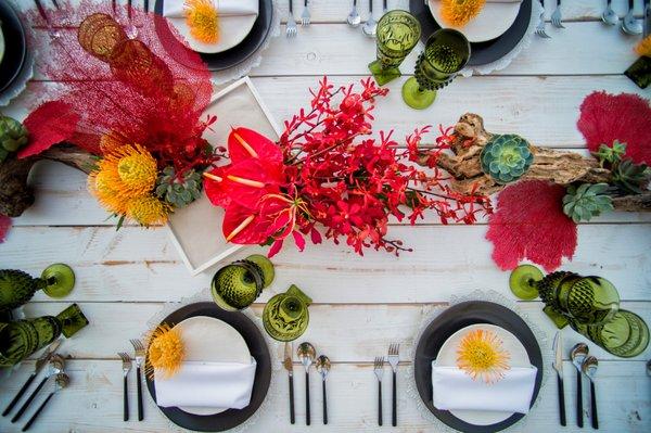 Tropical table scape on our white wash rustic tables