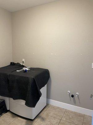 Before:  Laundry room with no cabinets.