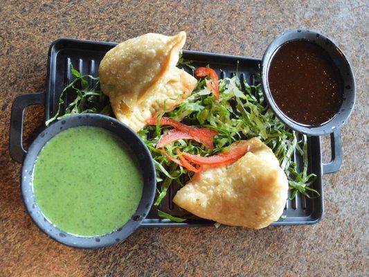 Veg Samosa with mint and tamarind chutney.