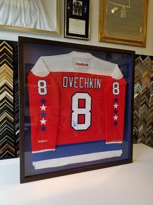 Sports jersey framing is one of our specialties...ALL CAPS!