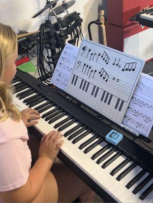 Writing original music boosts creativity and confidence!  Julia is going over her composition she wrote in less than 10 minutes!