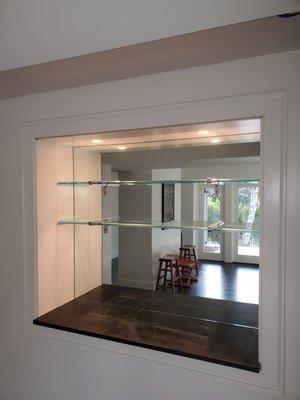 Installation of glass shelves and mirror.