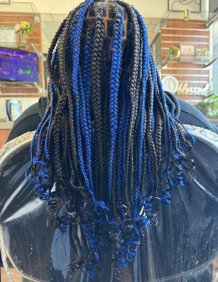 Blue & black knotless braids with curled ends.