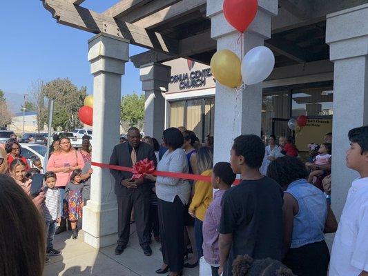 Ribbon cutting with Pastor Reegis