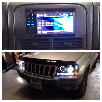 2002 Jeep Grand Cherokee with new headlights along with a custom double din radio in the factory location.