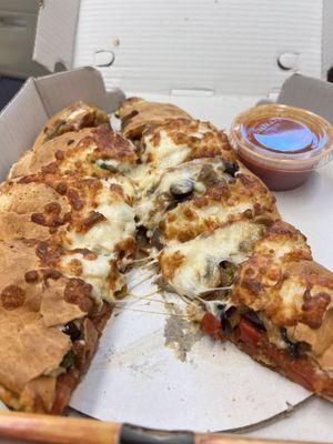 Veggie calzone apart.  Lots of different vegetables and tasty.