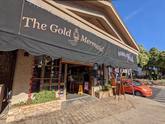 Outside. Storefront. Along with Hawaiian Gelato, it also says The Gold Mermaid.