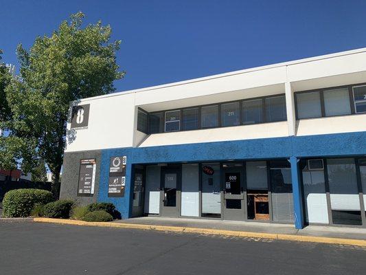 Outside of the building and entrance. You'll need to go up one floor and walk the corridor. The door to the massage is on the right.