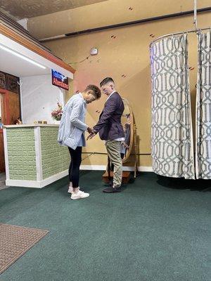 Suit jacket getting measured