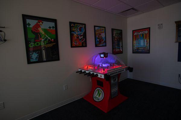 Game room dark with bubble hockey table flashing neon lights