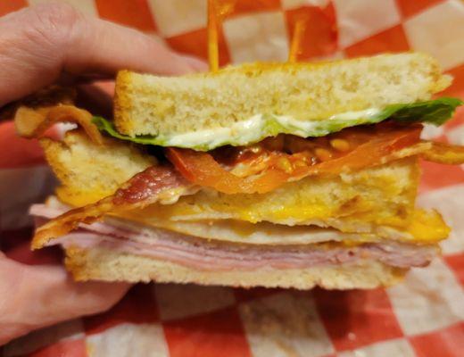 A tasty Club sandwich with crispy bacon for the win.  This is only half.  A cozy spot for lunch and a Vanilla Cinnamon Frappe.