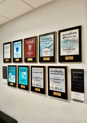 The wall proudly display's the orthodontist's achievements.