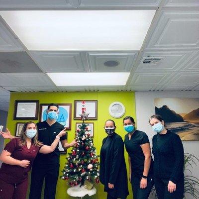 Dr Dino celebrating christmas with his colleagues in his dental office