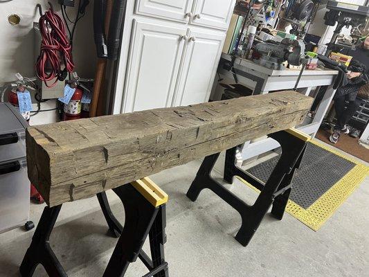 Reclaimed wood beam for fireplace mantle.